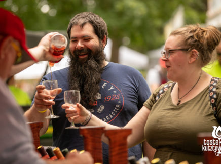Wine vendor pouring wine sample for couple at an outdoor wine & beer festival in Kutztown Pennsylvania