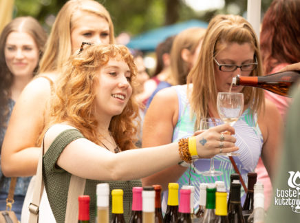 Wine vendor pouring wine sample for women at an outdoor wine & beer festival in Kutztown Pennsylvania