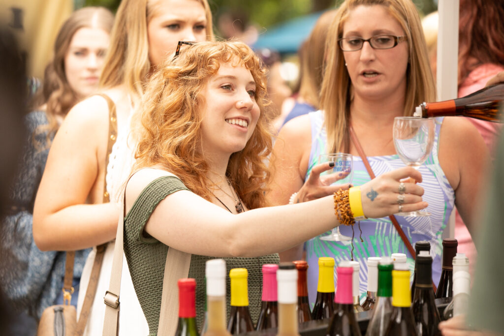 Young woman tasting wine at an outdoor wine festival in Kutztown, PA