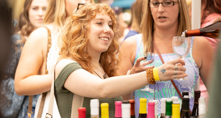 Young woman tasting wine at an outdoor wine festival in Kutztown, PA