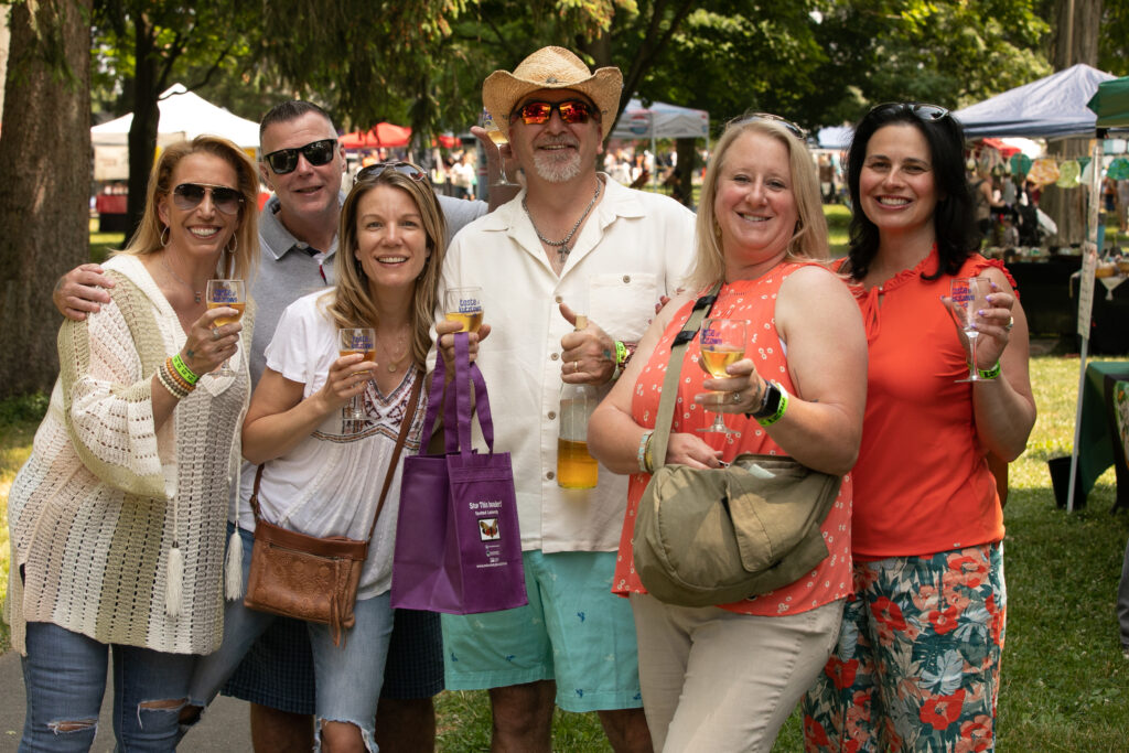 group of 6 friends at an outdoor wine festival